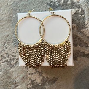 Gold hoops with dangling feature